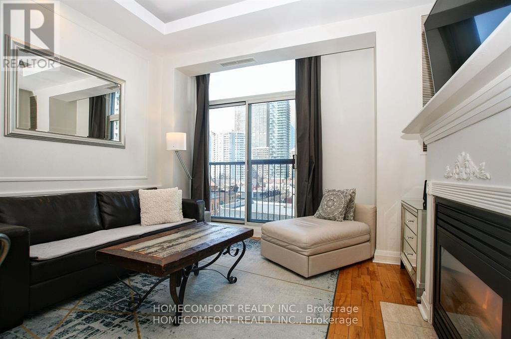 701 - 8 Wellesley Street E, Toronto, ON - Indoor Photo Showing Living Room With Fireplace