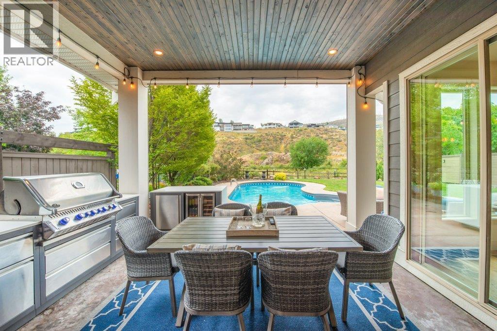 Covered back patio, perfect for dining alfresco - 425 Audubon Court, Kelowna, BC - Outdoor With In Ground Pool With Deck Patio Veranda With Exterior