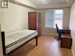 Bedroom featuring light wood-style floors and a desk -