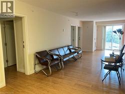 Living area with light wood-type flooring and baseboards -