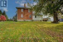 Side view of pretty brick Farm House -