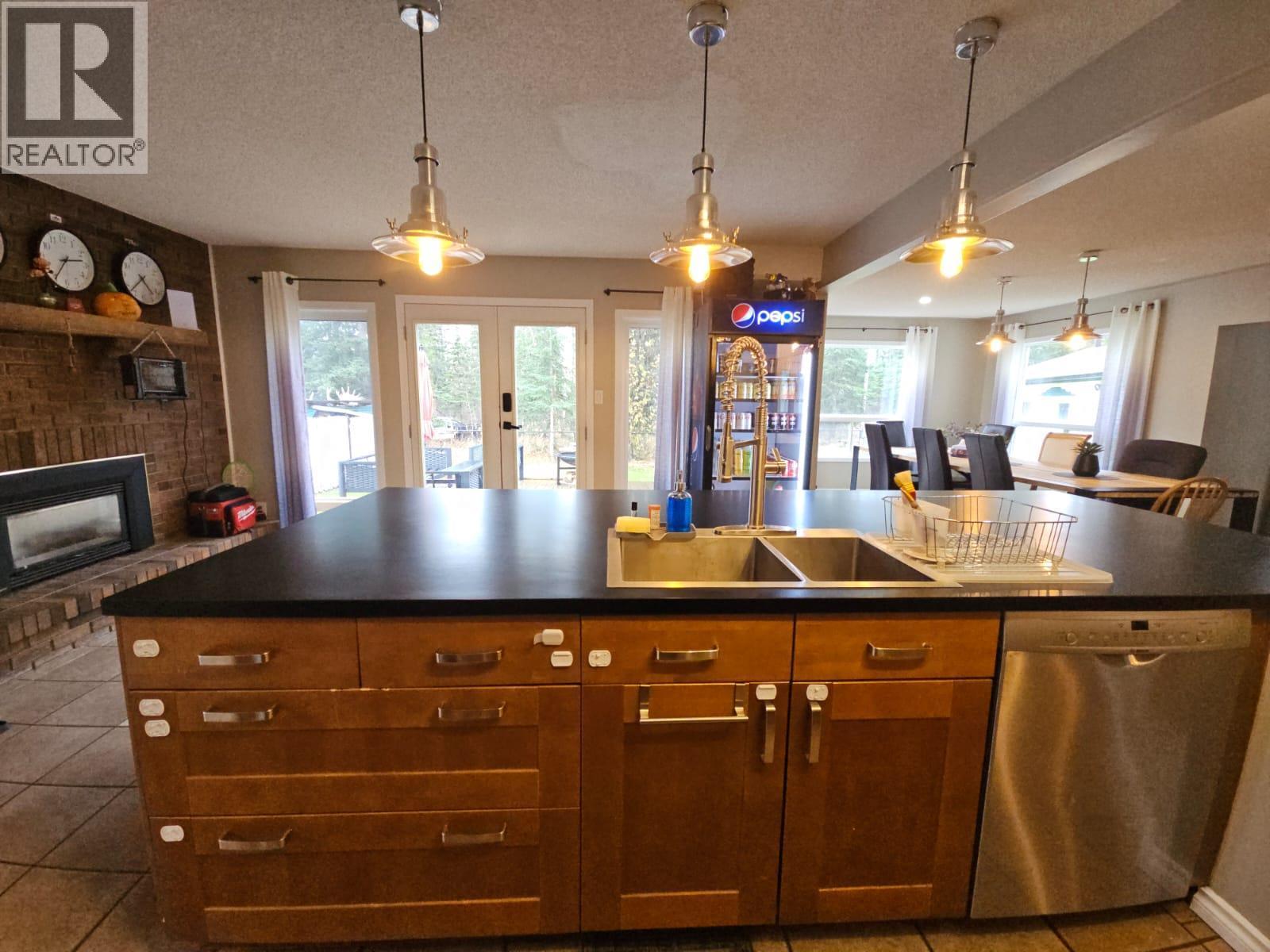 8 Sentinal Place, Tumbler Ridge, BC - Indoor Photo Showing Kitchen With Fireplace With Double Sink