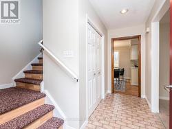 Stairway to second level by the front door. -