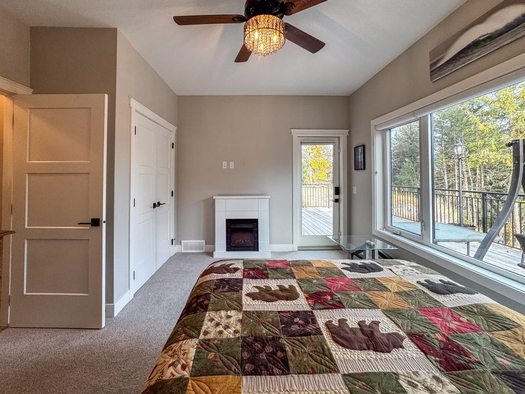 9905 Osprey Landing Drive, Wardner, BC - Indoor Photo Showing Bedroom With Fireplace