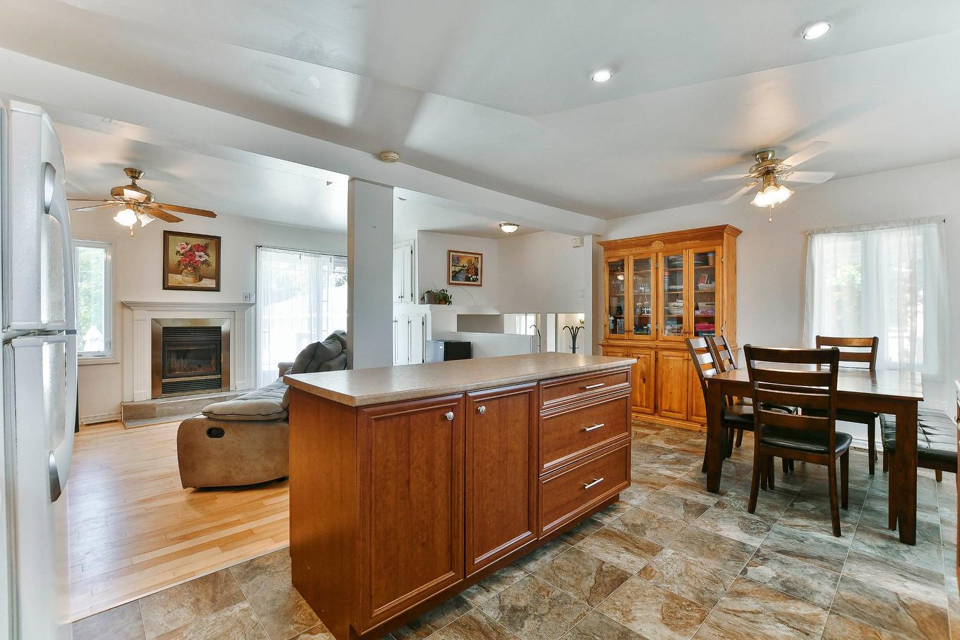Kitchen - 84 Rue Onulphe-Peltier, L'Épiphanie, QC - Indoor Photo Showing Dining Room With Fireplace