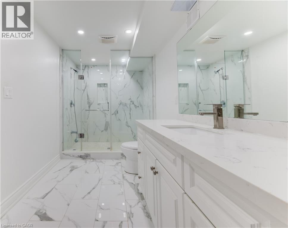 Full bath with vanity, a marble finish shower, light marble finish floors, and recessed lighting - 685 Briardean Road Unit# Lower, Cambridge, ON - Indoor Photo Showing Bathroom