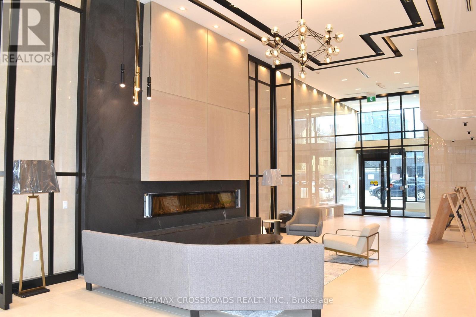 303 - 1 Belsize Drive, Toronto, ON - Indoor Photo Showing Other Room With Fireplace