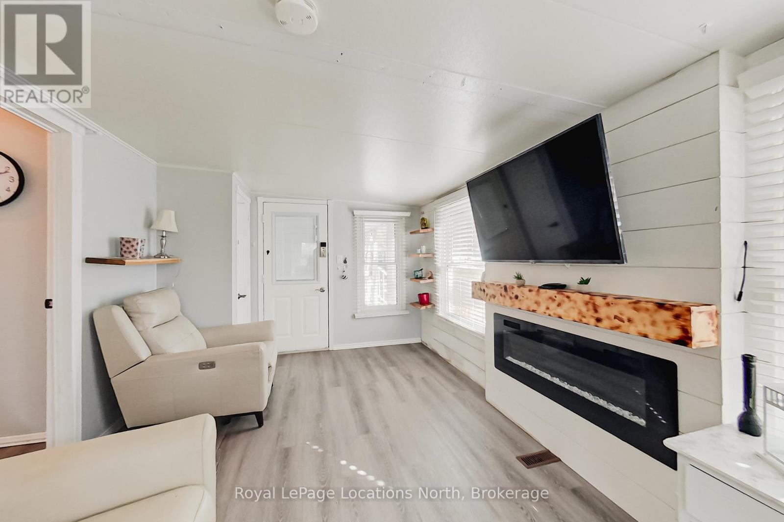 8 Prince Edward Drive, Springwater, ON - Indoor Photo Showing Living Room With Fireplace