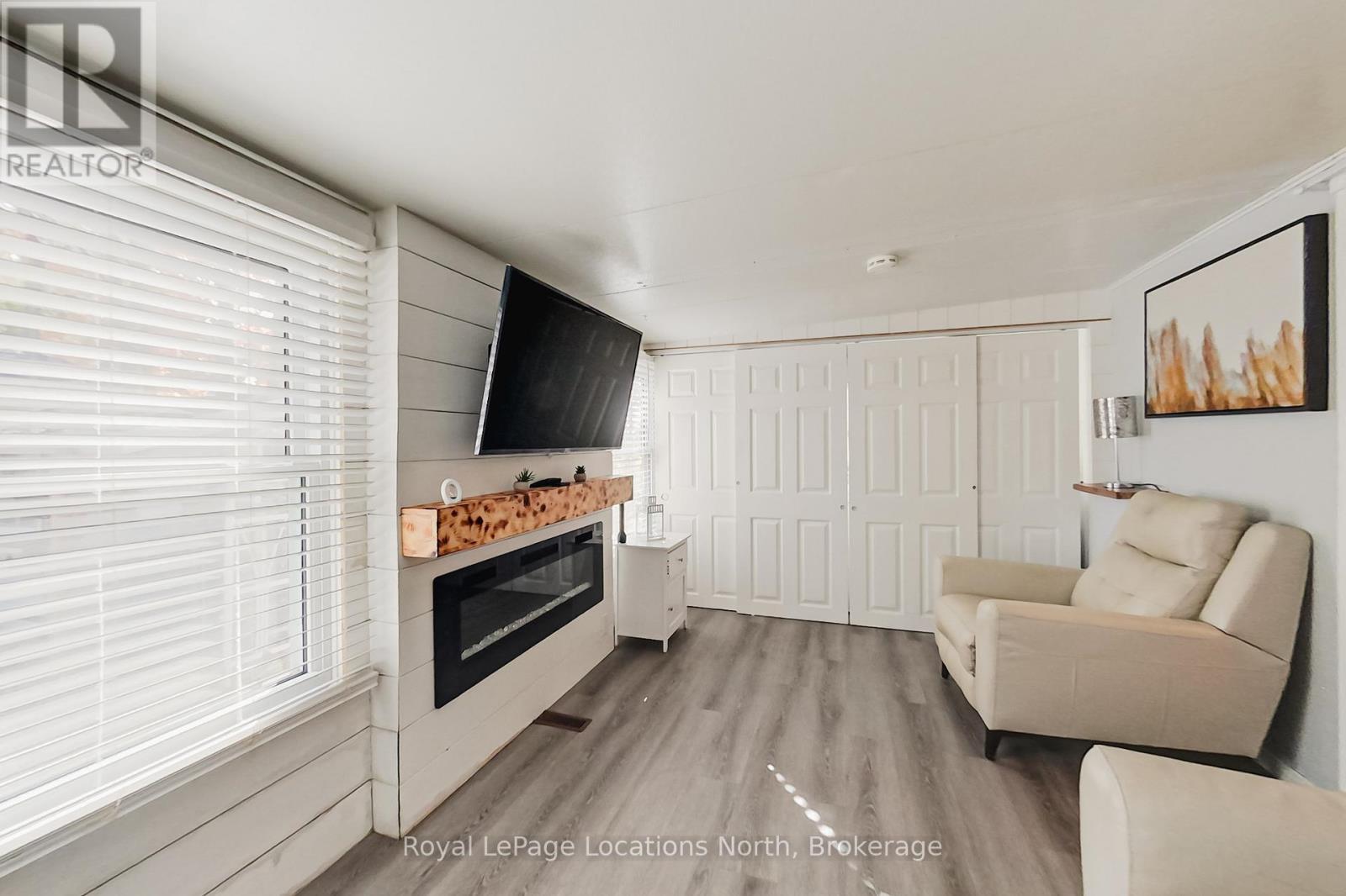 8 Prince Edward Drive, Springwater, ON - Indoor Photo Showing Living Room With Fireplace