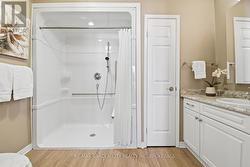 Very large step in shower with grab bars -