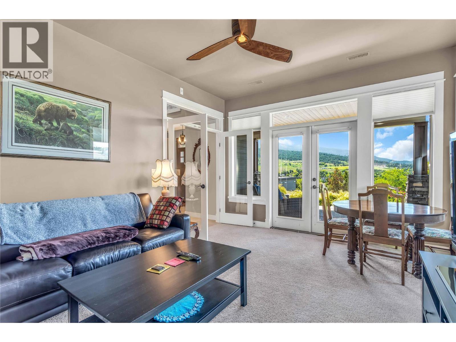 French Doors to Front Patio - 8780 Braeburn Drive, Coldstream, BC - Indoor Photo Showing Living Room