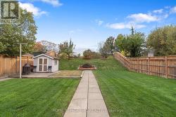 Very deep fenced lot with shed -