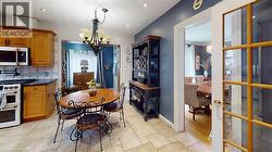 Dining space with a chandelier and recessed lighting -