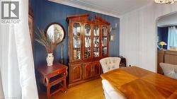 Dining room featuring arched walkways, crown molding, and light wood-style flooring -