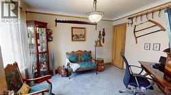 Carpeted office featuring crown molding and baseboards -