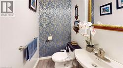 Half bathroom featuring vanity and toilet -