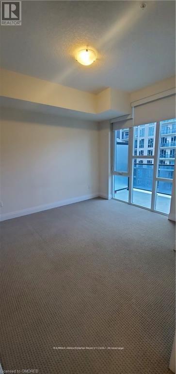 primary bedroom with walk-in closet and nook - 505 - 16 Concord Place, Grimsby, ON - Indoor Photo Showing Other Room