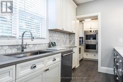 Kitchen with Oversized Sink and Built-In Ovens -