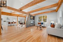 Living area featuring plenty of natural light, light wood finished floors, and a fireplace -