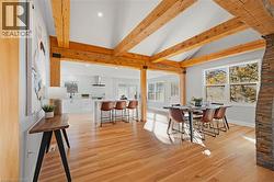 Dining room with light wood-type flooring and recessed lighting -