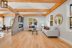 Living area featuring light wood finished floors and a fireplace -