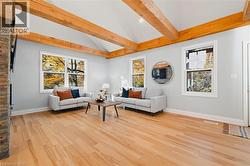Living room featuring light wood-type flooring and healthy amount of natural light -