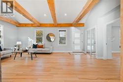 Living area with light wood-style floors and recessed lighting -