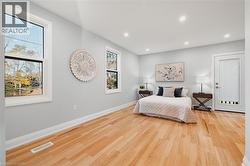 Bedroom with light wood-type flooring and recessed lighting -