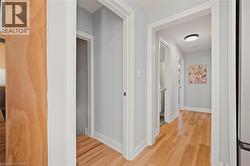 Hall with light wood finished floors and baseboards -