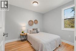 Bedroom featuring light wood finished floors and baseboards -