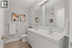 Bathroom with double vanity and toilet -