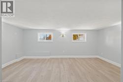 Basement featuring light wood-style floors and baseboards -