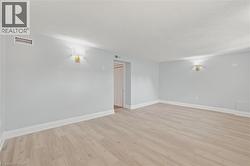 Spare room with light wood finished floors and a textured ceiling -
