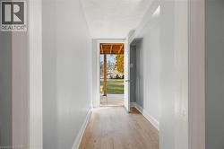 Entryway with baseboards and wood finished floors -