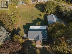 Aerial view of property and surrounding area with a tree filled landscape -