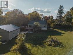 View of green lawn with stairs and a deck -