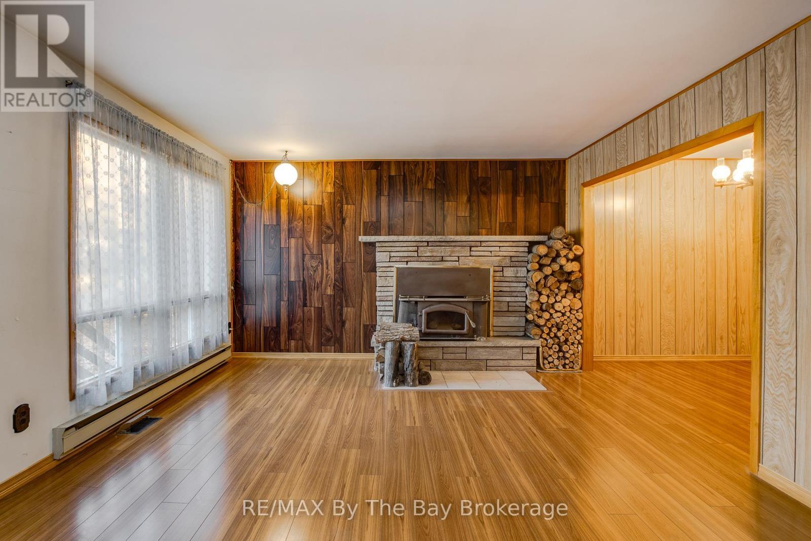 living room - 57 Tall Pines Drive, Tiny, ON - Indoor Photo Showing Living Room With Fireplace