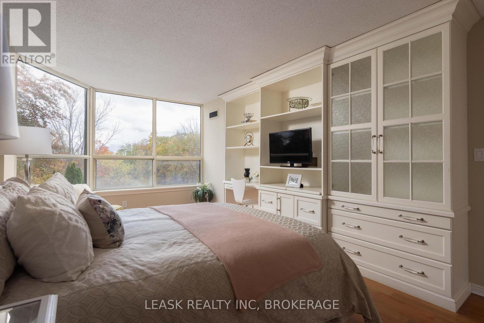 Primary retreat with built-ins & natural beauty. - 303 - 3 Towering Heights Boulevard, St. Catharines (Glendale/Glenridge), ON - Indoor Photo Showing Bedroom