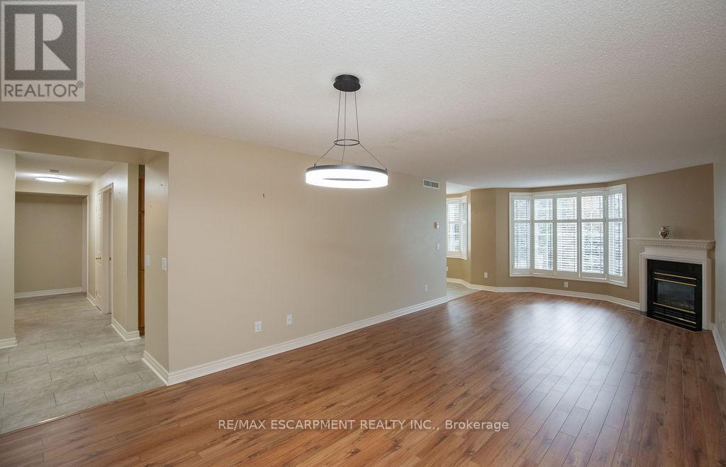 202 - 990 Golf Links Road, Hamilton, ON - Indoor Photo Showing Living Room With Fireplace