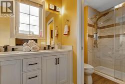 Primary ensuite with double vanity sinks & a walk in shower -