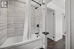 Tub with Tiled Shower on the Second Floor. -