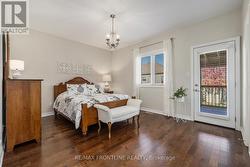 Primary bedroom w/ access to rear deck. -