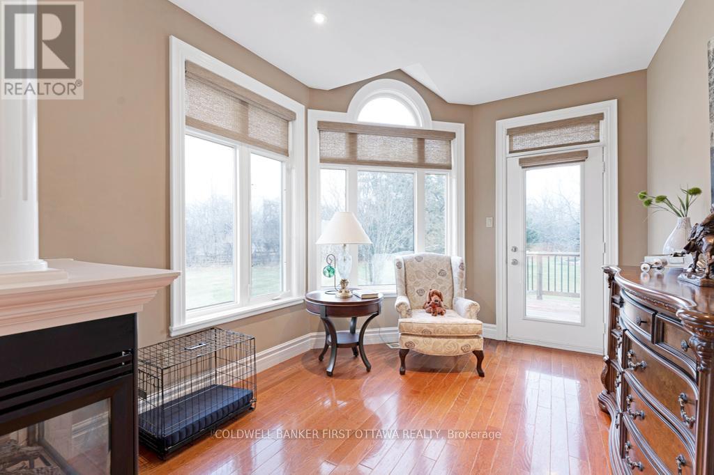 Primary's sitting nook garden door to deck - 556 West Point Drive, Drummond/North Elmsley, ON - Indoor With Fireplace