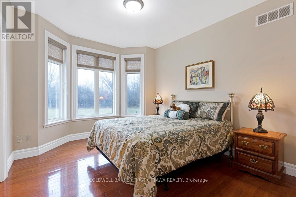 Second bedroom with alcove windows - 556 West Point Drive, Drummond/North Elmsley, ON - Indoor Photo Showing Bedroom