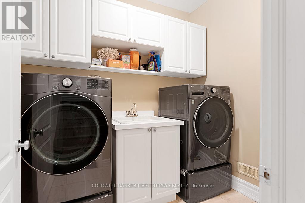 Laundry station has laundry sink and cupboards - 556 West Point Drive, Drummond/North Elmsley, ON - Indoor Photo Showing Laundry Room
