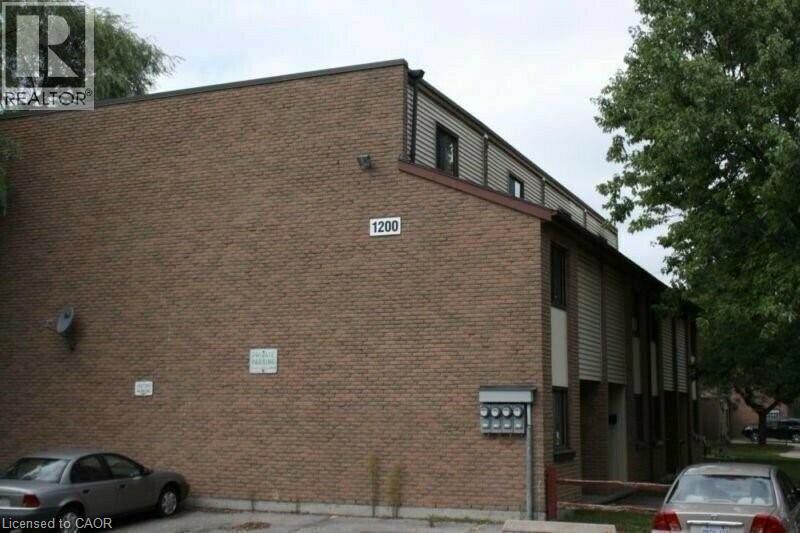 View of home's exterior with uncovered parking - 1200 Courtland Avenue E Unit# 25, Kitchener, ON - Outdoor