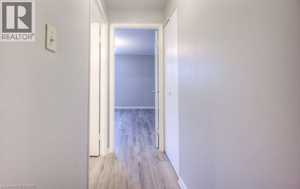 Hallway featuring light wood-style floors and baseboards - 1200 Courtland Avenue E Unit# 25, Kitchener, ON - Indoor Photo Showing Other Room