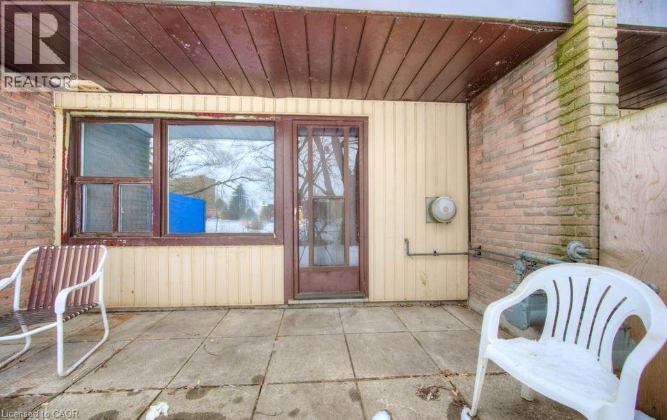 Doorway to property featuring brick siding and a sunroom - 1200 Courtland Avenue E Unit# 25, Kitchener, ON - Outdoor With Exterior