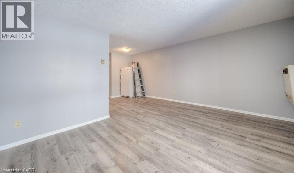 Empty room featuring light wood-style flooring and baseboards - 1200 Courtland Avenue E Unit# 25, Kitchener, ON - Indoor Photo Showing Other Room