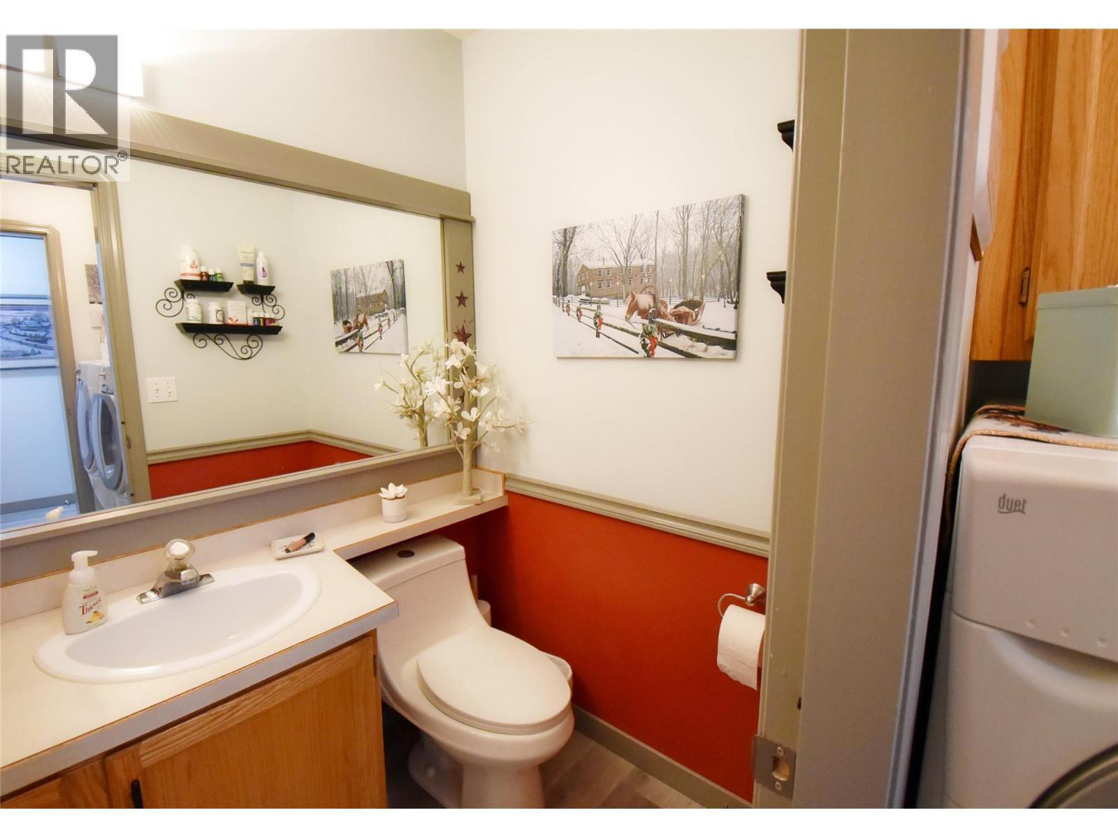 Powder room on main floor thru laundry room - 4404 20 Street Unit# 3, Vernon, BC - Indoor Photo Showing Bathroom